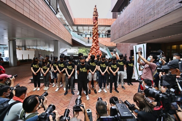 Members of the Hong Kong University Students' Union hold a moment of silence before the Pillar of Shame in Hong Kong on June 4, 2021. (Sung Pi-lung/The Epoch Times)