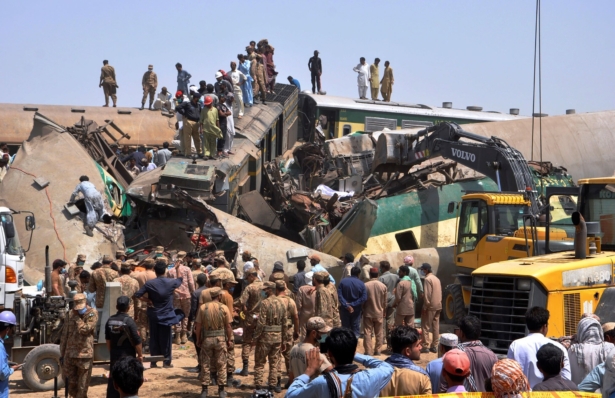 Soldiers and volunteers work at the site of a train collision in the Ghotki district in southern Pakistan, on June 7, 2021. (Waleed Saddique/AP Photo)