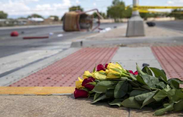 A bouquet of flowers from a mourner is placed near the basket of a hot air balloon which crashed in Albuquerque, N.M., on June 26, 2021. (Andres Leighton/AP Photo)