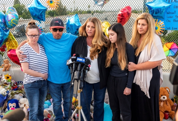 Family members of 6-year-old Aiden Leos stand at a makeshift memorial on the Walnut Avenue overpass at the 55 Freeway in Orange, Calif., on May 25, 2021. (Leonard Ortiz/The Orange County Register via AP)