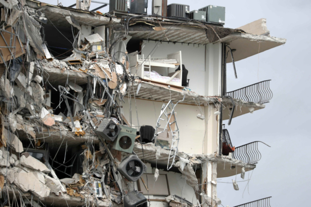 Items and debris dangle from a section of the oceanfront Champlain Towers South Condo that partially collapsed, in the Surfside area of Miami, Fla., on June 24, 2021. (Susan Stocker/South Florida Sun-Sentinel via AP)