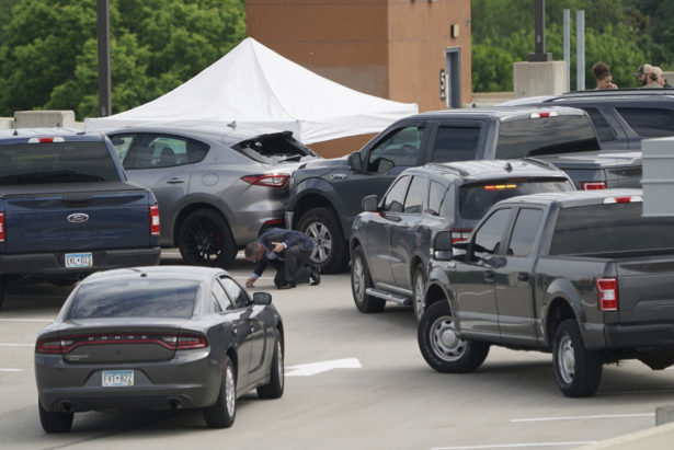 An investigator goes through the scene of crash believed to be part of an officer involved shooting on the top of a parking ramp in Minneapolis, Minn., on June 3, 2021. (Renee Jones Schneider/Star Tribune via AP)
