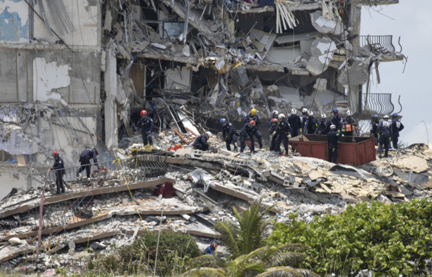 Members of the South Florida Urban Search and Rescue team look for possible survivors in the partially collapsed 12-story Champlain Towers South condo building in Surfside, Fla., on June 26, 2021. (Joe Raedle/Getty Images)