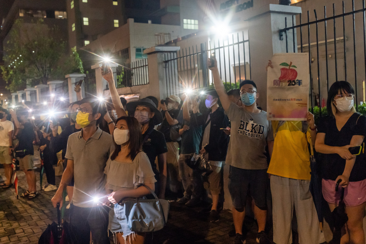 Supporters shine their smartphone lights towards the Apple Daily newspaper offices in Hong Kong, on June 23, 2021. (Anthony Kwan/Getty Images)