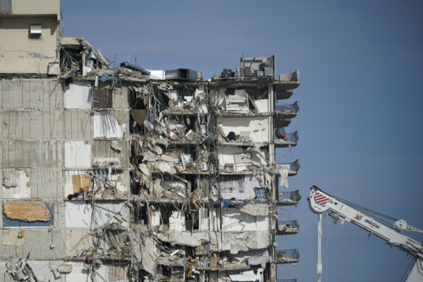A parked crane sits beside the still standing section of Champlain Towers South, which partially collapsed last Thursday, as rescue efforts on the rubble below were paused out of concern about the stability of the remaining structure, in Surfside, Fla., on July 1, 2021. (Mark Humphrey/AP Photo)