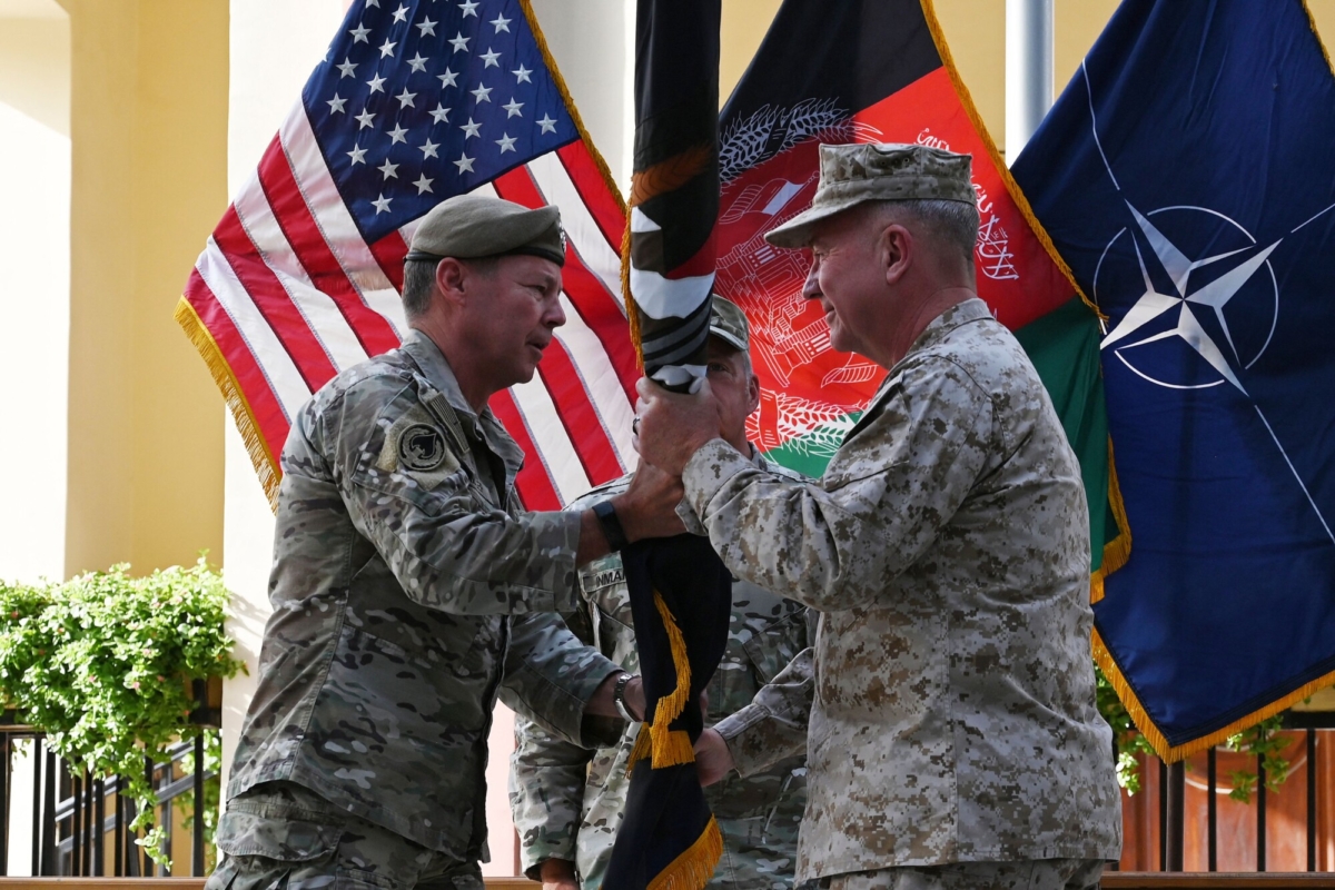 General Kenneth McKenzie (R), the head of U.S. Central Command, receives the flag of U.S.-led Resolute Support mission from General Austin "Scott" Miller, U.S. top commander of coalition forces in Afghanistan, during an official handover ceremony at the Resolute Support headquarters in the Green Zone in Kabul, on July 12, 2021. (Wakil Kohsar/AFP via Getty Images)