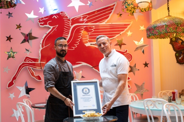 Chef Frederick Schoen-Kiewert (L) and Chef Joe Calderone pose with the certificate and The Creme de la Creme Pommes Frites, the world's most expensive french fries, according to the Guinness Book of World Records, at Serendipity 3 restaurant New York City, N.Y., United States, on July 23, 2021. (Eduardo Munoz/Reuters)