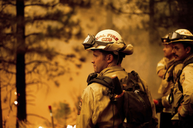 Firefighter Jesse Forbes monitors flames