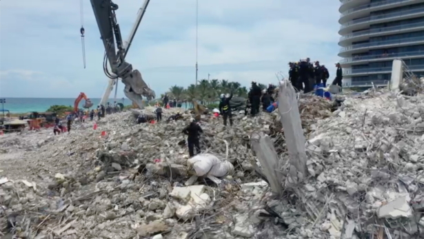 Search-and-rescue personnel work on the debris of the collapsed Champlain Towers South condominium in Surfside, Fla., on July 5, 2021. (Miami-Dade Fire Rescue Department/Handout via Reuters)