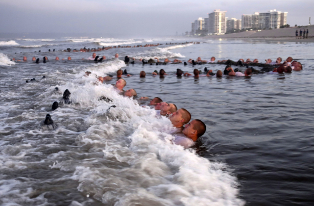 SEAL candidates participating in "surf immersion" during Basic Underwater Demolition/SEAL (BUD/S) training at the Naval Special Warfare (NSW) Center in Coronado, Calif. on May 4, 2020. (MC1 Anthony Walker/U.S. Navy via AP)