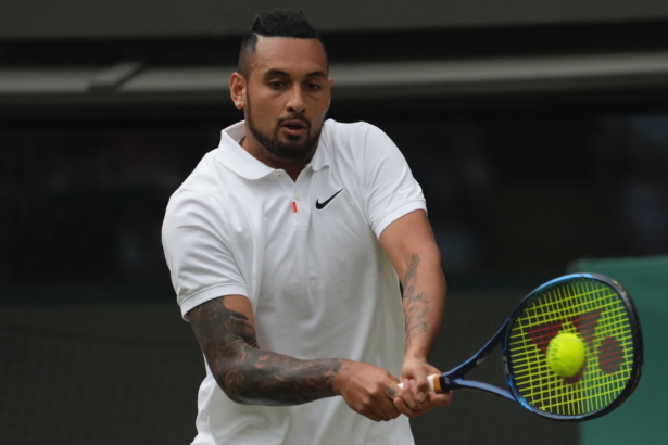 Australia's Nick Kyrgios plays a return to Canada's Felix Auger-Aliassime during the men's singles third-round match on day six of the Wimbledon Tennis Championships in London, on July 3, 2021. (Alberto Pezzali/AP Photo)