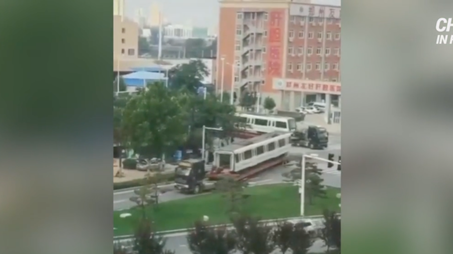 Soaked Zhengzhou Subway Cars Transported Away