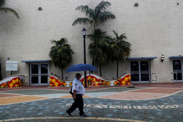 A man walks with an umbrella ahead of Tropical Storm Elsa in the Little Havana neighborhood of Miami, Fla., on July 5, 2021. (Shannon Stapleton/Reuters)