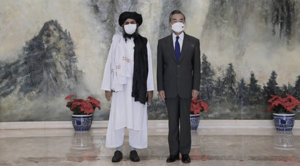 Taliban co-founder Mullah Abdul Ghani Baradar (L) and Chinese Foreign Minister Wang Yi pose for a photo during their meeting in Tianjin, China, on July 28, 2021. (Li Ran/Xinhua via AP)