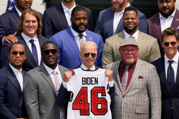 President Joe Biden, surrounded by members of the Tampa Bay Buccaneers, poses for a photo holding a jersey during a ceremony on the South Lawn of the White House, where Biden honored the Super Bowl Champion Tampa Bay Buccaneers for their Super Bowl LV victory, in Washington, on July 20, 2021. (Andrew Harnik/AP Photo)