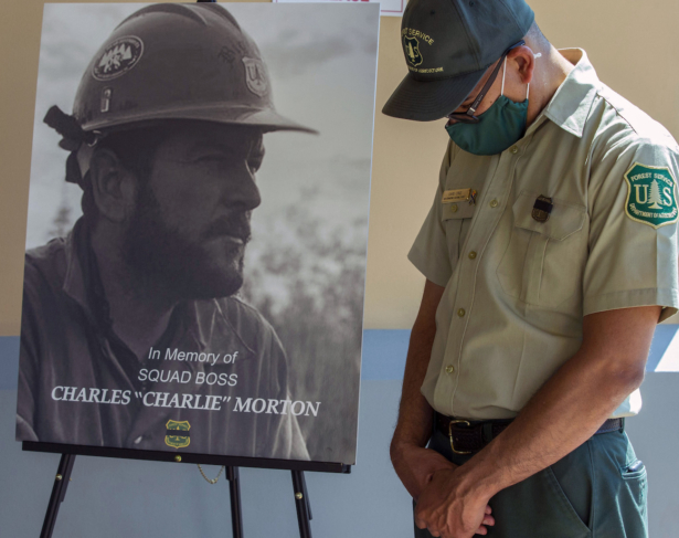 San Bernardino National Forest firefighter David Cruz lowers his head during a memorial for Charles Morton, the U.S. Forest Service firefighter assigned to the Big Bear Hotshots who was killed in the line of duty on the El Dorado Fire at The Rock Church in San Bernardino, Calif., on Sept. 25, 2020. (Terry Pierson/The Orange County Register via AP)