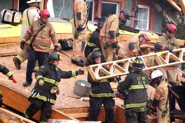 Emergency personnel clear debris as they search for trapped construction workers after a building undergoing construction collapsed in Washington on July 1, 2021. (Evelyn Hockstein/Reuters)