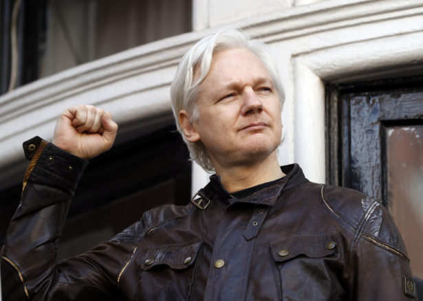 Julian Assange greets supporters outside