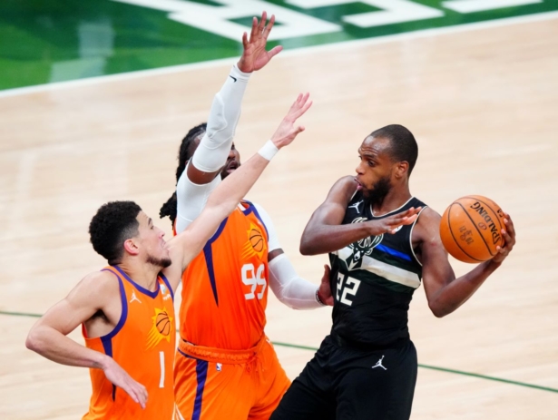 Milwaukee Bucks forward Khris Middleton (22) defended by Phoenix Suns forward Jae Crowder (99) and guard Devin Booker (1) during game six of the 2021 NBA Finals at Fiserv Forum on Jul 20, 2021. (Mark J. Rebilas-USA TODAY Sports)