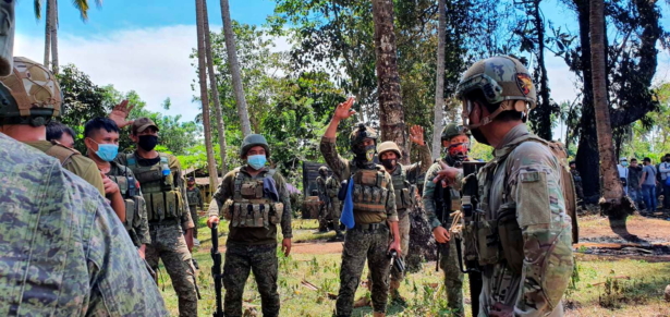 Army personnel work at the site after a Philippines Air Force Lockheed C-130 plane carrying troops crashed on landing in Patikul, Sulu province, Philippines, on July 4, 2021. (Armed Forces of the Philippines—Joint Task Force Sulu/Handout via Reuters)