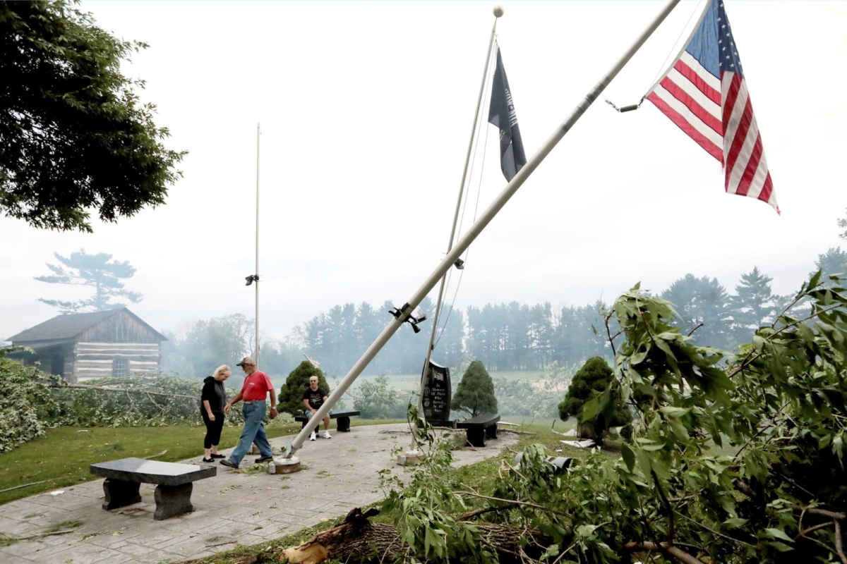 Following an overnight storm, Jefferson County residents inspect damage at Dahnert Park, in Concord, Wis., on July 29, 2021. (John Hart/Wisconsin State Journal via AP)