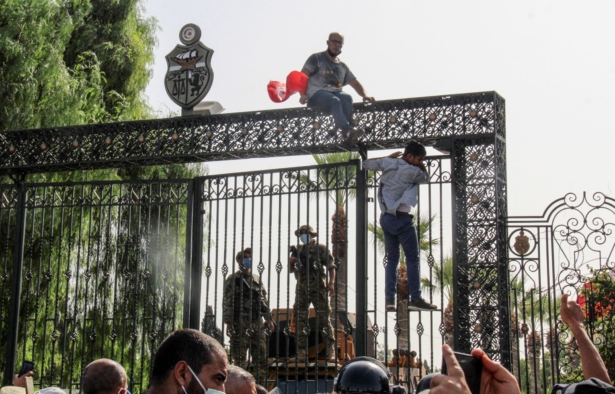Tunisian soldiers guard the main entrance of the parliament as demonstrators gather outside the gate in Tunis, Tunisia, on July 26, 2021. (Hedi Azouz/AP Photo)