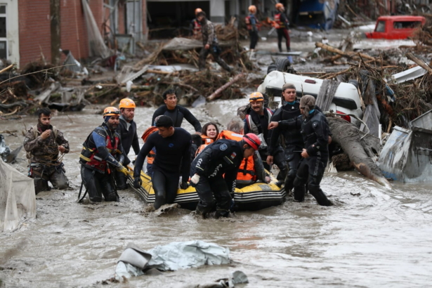 Search and Rescue team members evacuate locals during flash floods, which have swept through towns in the Turkish Black Sea region, in Bozkurt, a town in Kastamonu Province, Turkey, on Aug. 12, 2021. (Onder Godez/Ministry of Interior Disaster and Emergency Management Authority (AFAD) Press Office/Handout via Reuters)