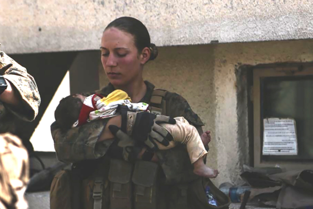 Sgt. Nicole Gee holding a baby at Hamid Karzai International Airport in Kabul, Afghanistan in an undated photo. (U.S. Department of Defense via AP)