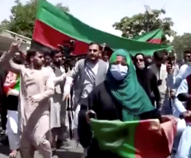 People march with the Afghan national flags in Kabul, Afghanistan, in this still image taken from a video on Aug. 19, 2021. (Courtesy Sada e Jameya News Agency/via Reuters)