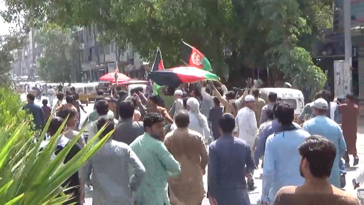 In this screengrab taken from a video, people carry Afghan flags as they take part in an anti-Taliban protest in Jalalabad, Afghanistan, on Aug. 18, 2021. (Pajhwok Afghan News/Handout via Reuters)
