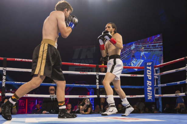 Nico Ali Walsh, right, faces Jordan Weeks during a middleweight boxing bout, near Tulsa, Okla., on Aug. 14, 2021. (Brett Rojo/Tulsa World via AP)
