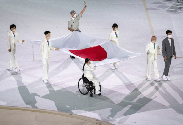 Athletes from Japan Miki Matheson, Mineho Ozaki, Taiyou Imai, Erina Yuguchi, Kaori Icho, and Tskumi Asatani carry the national flag of Japan into the Olympic Stadium at the start of the Paralympic Opening Ceremony Tokyo 2020 Paralympic Games in Tokyo, on Aug. 24, 2021. (Joe Toth for OIS/via AP)