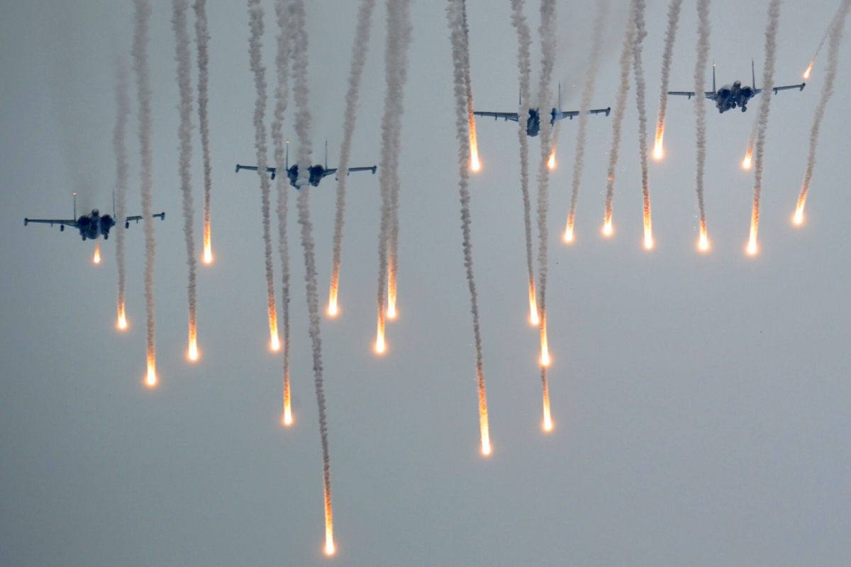 Helicopters fly above servicemen running to positions during the joint Russian-Belarusian military exercises Zapad-2017 (West-2017) at a training ground near the town of Borisov on Sept. 20, 2017. (Sergei Gapon/AFP via Getty Images)