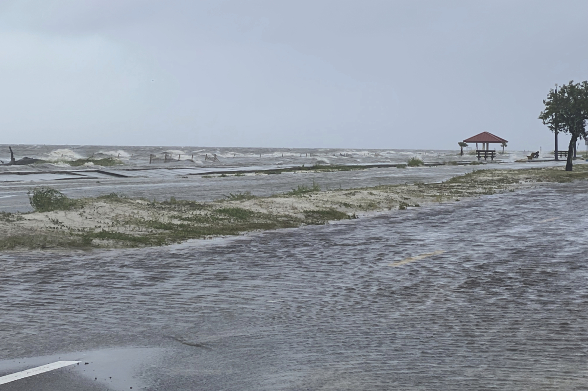 Highway 90 westbound in Pass Christian, Miss. overflows with flooding waters early as a result of the arrival of Hurricane Ida on Aug. 29, 2021. (Hunter Dawkins/The Gazebo Gazette via AP)