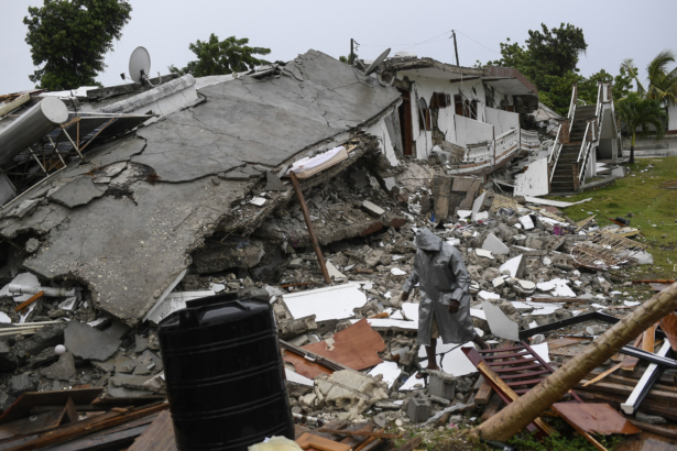 A man walks on the rubble of a collapsed hotel the morning after Tropical Storm Grace swept over Port Salut, Haiti, on Aug. 17, 2021. (Matias Delacroix/AP Photo)