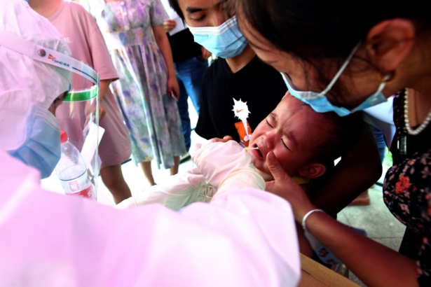 A medical worker takes swab samples