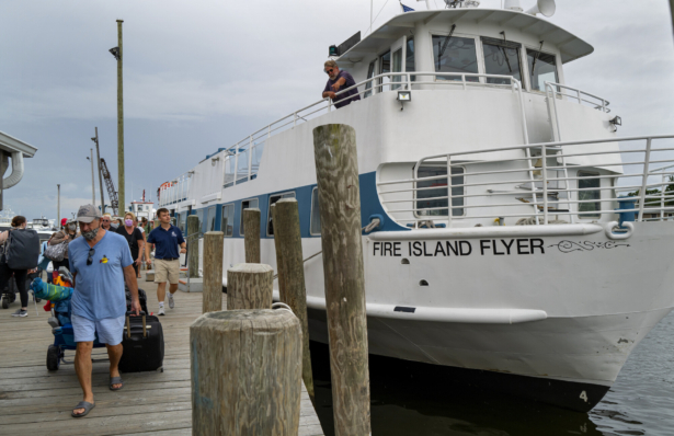 People disembark from a ferry in Bay Shore, N.Y., on Aug. 21, 2021, as it arrived from Fire Island. (Craig Ruttle/AP Photo)