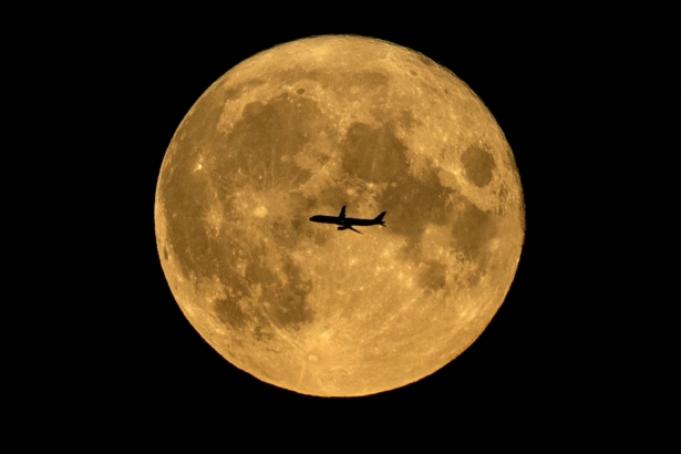 A plane is silhouetted against full moon in Moscow, on Aug. 22, 2021. (Kirill Kudryavtsev/AFP via Getty Images)