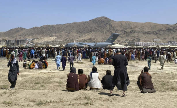 Hundreds of people gather near a U.S. Air Force C-17 transport plane at the perimeter of the international airport in Kabul, Afghanistan, on Aug. 16, 2021. (Shekib Rahmani/AP Photo)