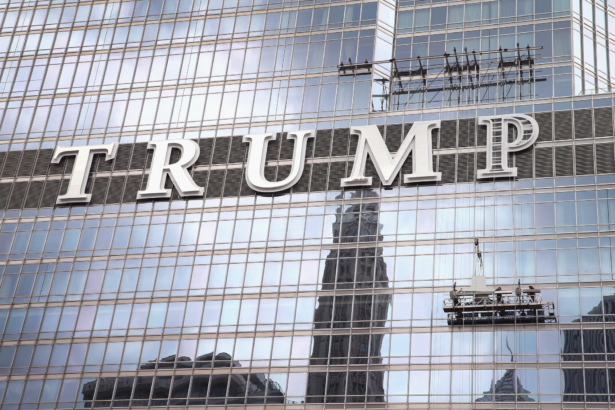 Workers install the final letter for a giant TRUMP sign on the outside of the Trump Tower in Chicago on June 12, 2014. (Scott Olson/Getty Images)