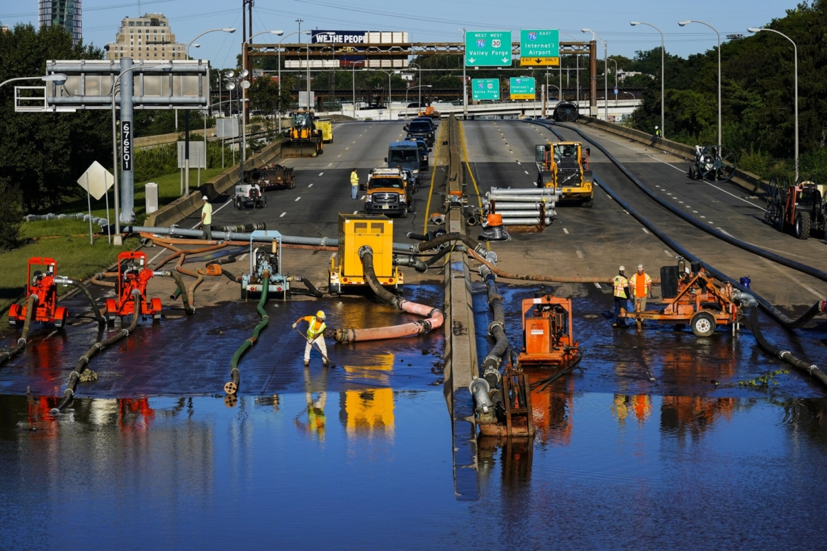 Workers pump water from a flooded section of Interstate 676 in Philadelphia, on Sept. 3, 2021. (Matt Rourke/AP Photo)