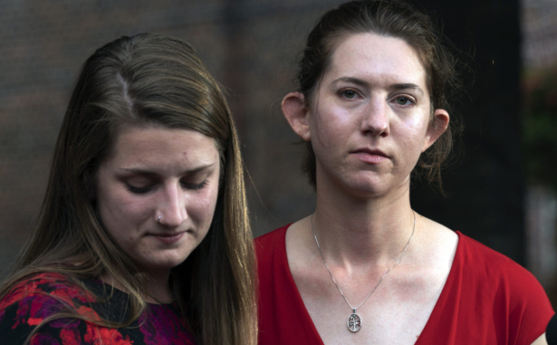 Summerleigh Winters Geimer (C) and her sister Montana Winters Geimer (R), daughters of Wendi Winters, a community beat reporter who was killed in the Capital Gazette newsroom shooting, react during a news conference following the sentencing verdict of Jarrod W. Ramos, in Annapolis, Md., on Sept. 28, 2021. (Jose Luis Magana/AP)