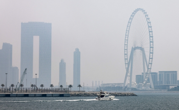 A speedboat cruises near the Ain Dubai (Dubai Eye) 250-meters high Ferris wheel in the Gulf Emirate, Dubai, on Aug. 26, 2021. (Karim SAHIB/AFP via Getty Images)