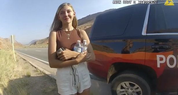 In this screenshot from a police camera video, Gabrielle “Gabby” Petito talks to a police officer after police pulled over the van she was traveling in with her boyfriend, Brian Laundrie, near the entrance to Arches National Park, Utah, on Aug. 12, 2021. (The Moab Police Department via AP)