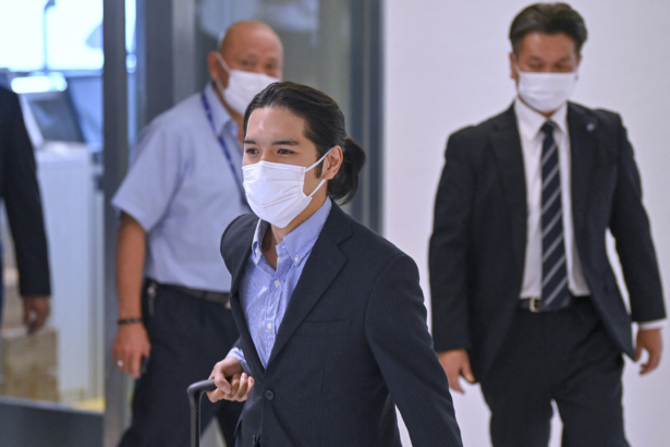 Kei Komuro (C), the boyfriend of Japan's Princess Mako, arrives at Narita airport in Chiba Prefecture from the United States, on Sept. 27, 2021. (Kazuhiro Nogi/AFP via Getty Images)
