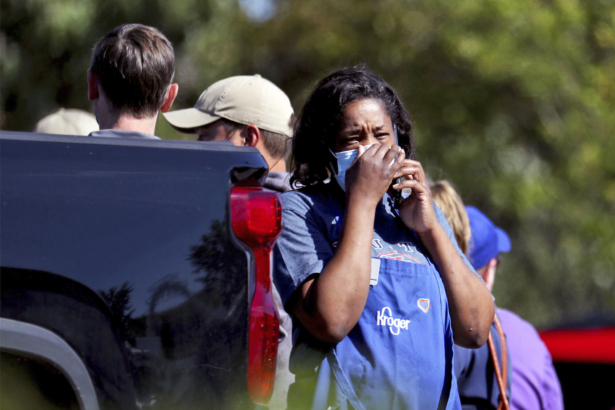 A Kroger employee talks on a cellphone following a shooting at a Kroger's grocery store in Collierville, Tenn., on Sept. 23, 2021. (Patrick Lantrip/Daily Memphian via AP)