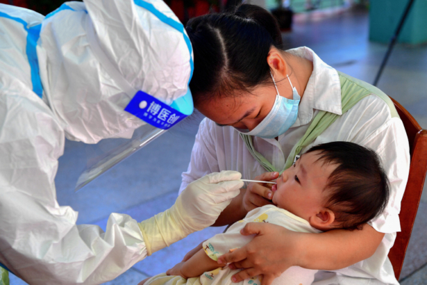 A child undergoes a nucleic acid test for the Covid-19 coronavirus in Xianyou county, Putian city, in China's eastern Fujian province on September 13, 2021. (CNS/AFP via Getty Images)