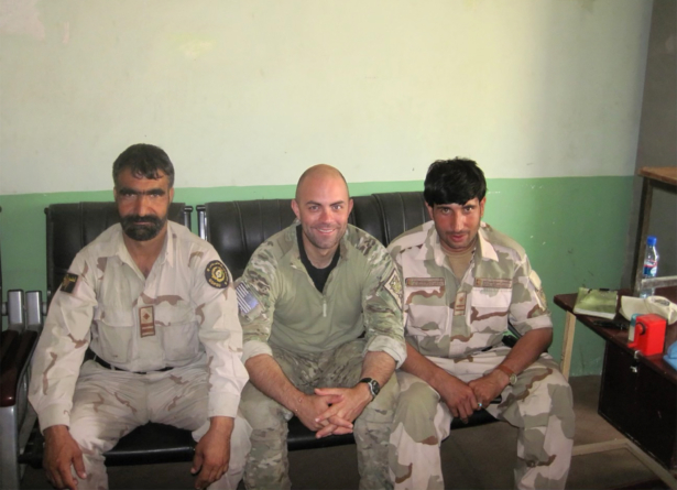 Ryan Brummond, U.S. Special Forces Officer, center, is seated next to Mohammad Khalid Wardak, right, in Afghanistan. (Ryan Brummond via AP)