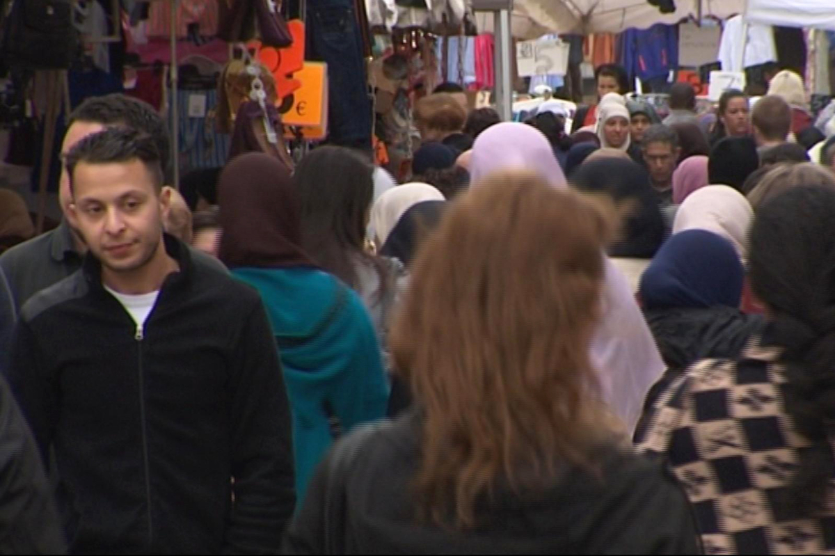 Salah Abdeslam, left, strolling through the Molenbeek market in Brussels, Belgium on April 13, 2016. (Bruzz via AP/File)