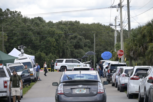 Vehicles from members of the media and curious passersby line a road outside the entrance of the Carlton Reserve during a search for Brian Laundrie, Tuesday, Sept. 21, 2021, in Venice, Fla. (Phelan M. Ebenhack/AP Photo)